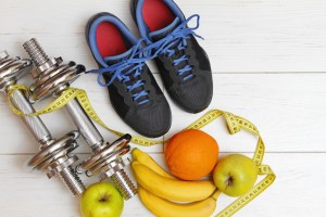 fitness equipment and healthy nutrition on white wooden plank fl